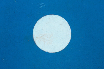 Details of sports field markings in the form of white circles on a blue surface