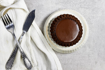 Chocolate Tart On Plate With Linen Cloth And Vintage Silverware Setting