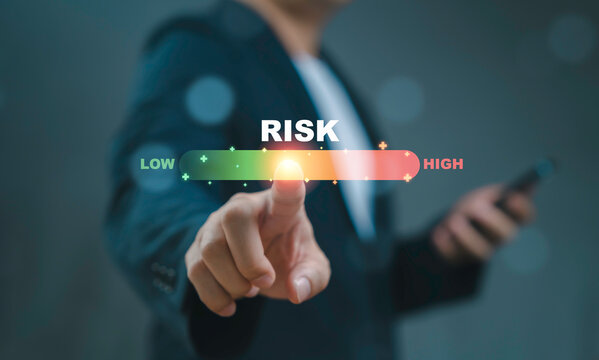Businessman touching to colorful risk scale indicator and analysis for evaluation business investment risk before decision and judgment concept.
