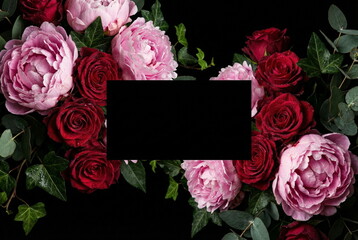 Flowers frame and black blank card mockup on black background, Space for text.Floral border from pink peonies, bordo roses .Holiday background. Vintage floral, dark flower