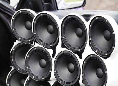 Large Array Of Mid-Range Speakers In Custom-Built Housing. White And Black Enclosure With Paint Drip Design.