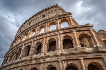Obraz premium Ancient Roman amphitheater exterior against a cloudy sky. Dramatic perspective and architecture