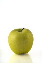 Green apple isolated on white background with reflection and copyspace.