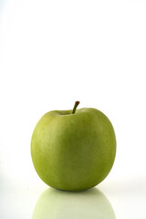Green apple isolated on white background with reflection and copyspace.