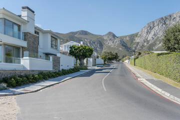 houses on street and barren hills at Hermanus, South Africa
