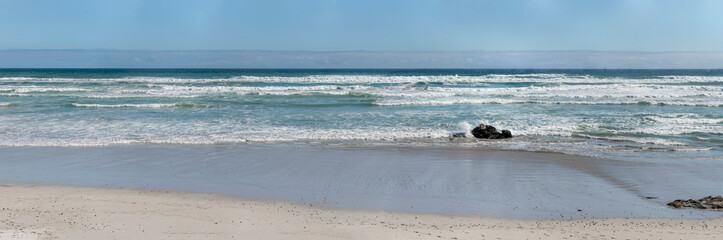 waves and sand on shore at Cliff Path, Hermanus, South Africa