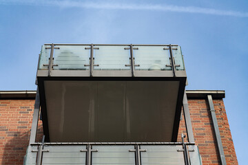 Balcony above a brick building under a clear blue sky