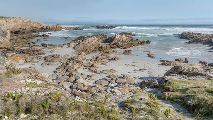 sand and cliffs at Platbank Beach cove, Hermanus, South Africa