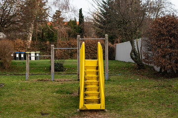 Playground slide in a park on a cloudy day