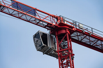 Red construction crane in a clear sky during daytime