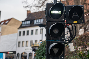 Traffic light shows signals for pedestrians and vehicles in city
