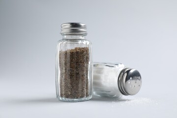 Salt and pepper shakers on white background, closeup