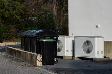 Trash bins and air conditioning units in urban setting