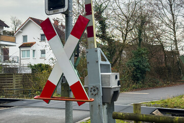 Railroad crossing signal at a quiet street in a residential area