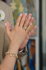 hands of the groom and bride, bride and groom hands, engagement ring on hands, intimate wedding moment, love and commitment concept