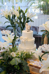 white wedding cake with floral decor, elegant wedding reception table, romantic celebration concept, classic bridal cake centerpiece, wedding cake, cake