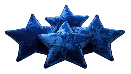 Four plush, indigo star-shaped pillows arranged artfully against a black background, emphasizing their velvet texture and shape