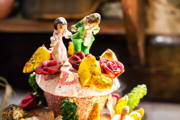 A homemade wedding loaf in the village with decorations against a backdrop. Village baking,...
