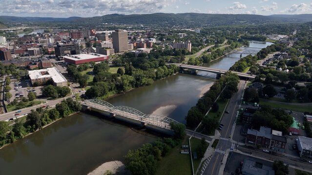 Binghamton, NY downtown city skyline with office buildings, historic architecture, public parks and river flowing through town on Summer sunny warm day