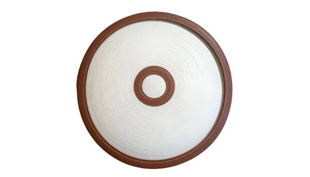 A circular white object with concentric lines, brown trim, and a small brown center on black - Powered by Adobe