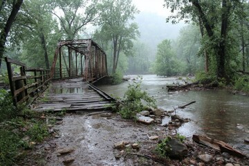 Rusted metal truss bridge spans a flooded river with trees in the background