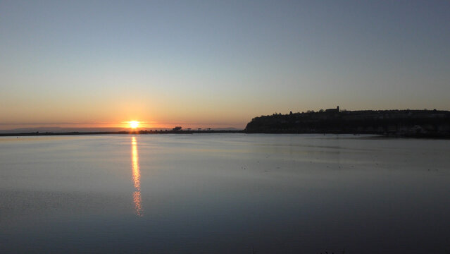 Calm Morning Sunrise over Cardiff Bay showing still water and the Barrage