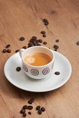 Obraz premium Minimal espresso cup on wooden table with coffee beans