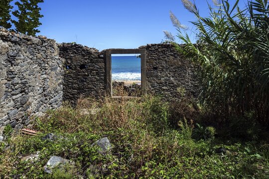 Crumbling wall with window frame, view to the sea, Porto da Cruz, Madeira, Portugal