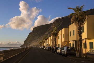 Coastal road with houses in Paul do Mar, evening light, dramatic cloud atmosphere, Madeira, Portugal