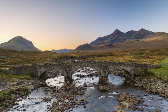 River Sligachan with old stone bridge, Cuillin Mountains in the background, Isle of Skye, Highlands, Inner Hebrides, Scotland, United Kingdom