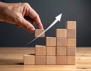 Hand adding wooden block to staircase, upward arrow symbolizes growth and progress