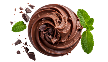Close-up of swirled chocolate frosting with mint leaves and chocolate chunks on black