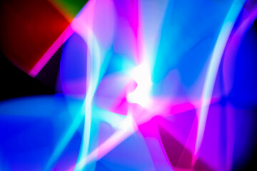 Obraz premium Abstract image of light painting with blur effect. Colorful vibrant lights are swirling in the dark background. It can be used as wallpaper, background or design element