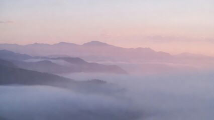 Serene mountain ranges veiled in morning fog and rosy sky