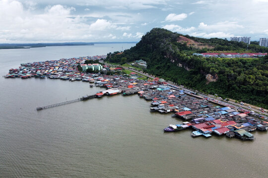 Sandakan, Sabah / Malaysia: Drone view of Kampung Buli Sim Sim, a water village on stilts on the coast of Sandakan reachable by plank walkways, depicts lives of some of the local fishermen families.