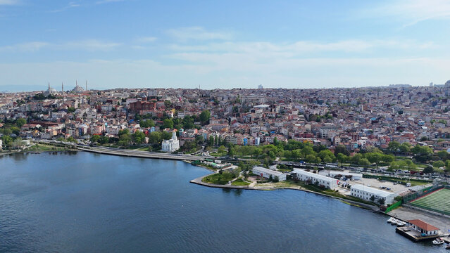 High altitude wide aerial view of the Golden Horn coastline and urban residential buildings on May 5, 2025 in Balat, Istanbul