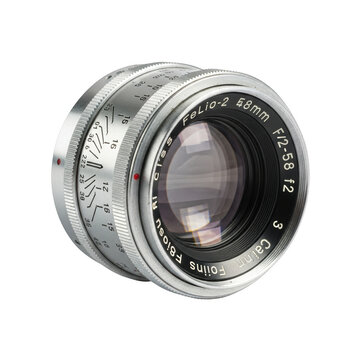 Silver metal camera lens with f12 58mm aperture and distance markings on black background photography