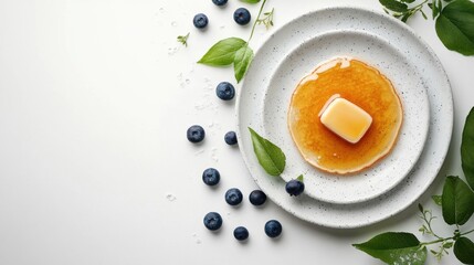 Top view breakfast pancakes with honey butter and blueberries on white background