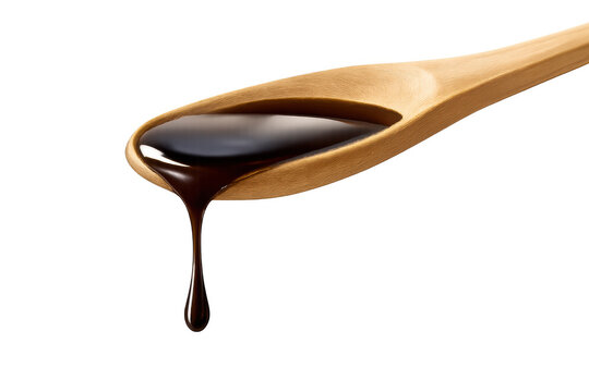 Dark liquid sauce dripping from a wooden spoon, adding flavor and richness to food, transparent background