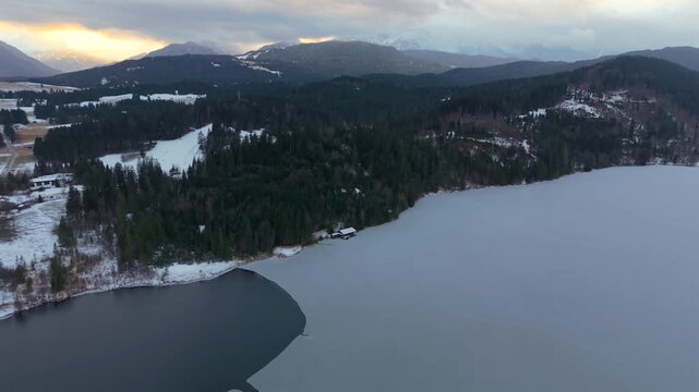 Drone panorama above Barmsee near Kruen and Wallgau, Bavaria. Winter aerial landscape with frozen lake and Karwendel Alps in the background. Luftaufnahme per Drohne vom Barmsee in Bayern, Deutschland.