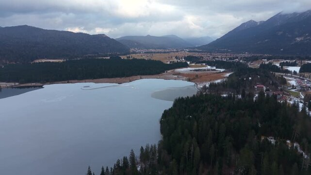 Drone video of Barmsee north of Mittenwald, Bavaria. Winter aerial view of alpine lake, partially frozen, with snow and mountain landscape in southern Germany. Luftaufnahme vom Barmsee in Bayern