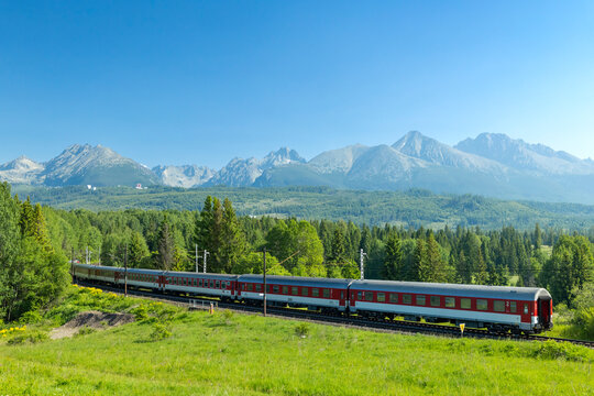 Train traveling through High Tatras mountains in Slovakia