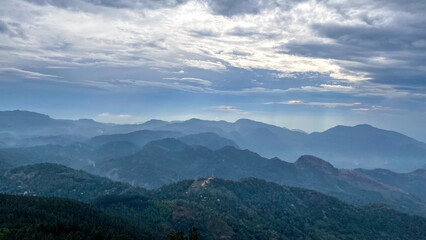 Fototapeta premium Whispering blue-grey mountains under dramatic skies evoke tranquility, perfect for meditation retreat or Harvest Moon Festival inspiration