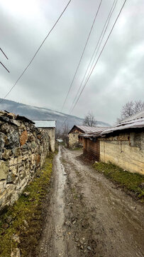 Rugged, misty mountain pathway under brooding skies evokes Transylvanian folklore and La Fete des Gueux's rustic charm