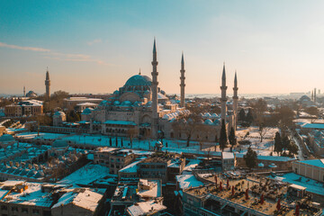 Obraz premium Suleymaniye Mosque stands over the white-covered roofs, adding a calm winter character to the city’s vast silhouette.