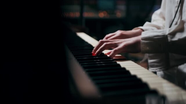 Close-up of female hands playing piano keys, shot handheld. Artistic music performance, classical instrument, creativity, emotional moment, soft light and elegant lifestyle.