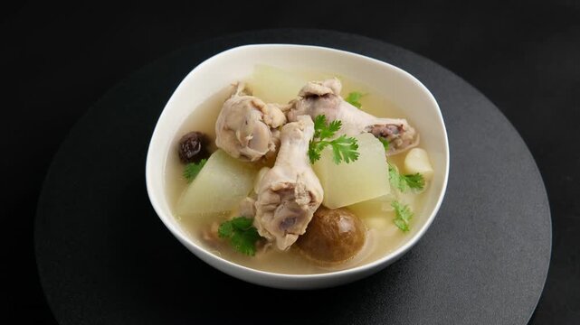 Winter Melon with Chicken wings (drumettes) and preserved lime soup in white bowl.Thai food.