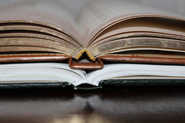 Two open books stacked on a table