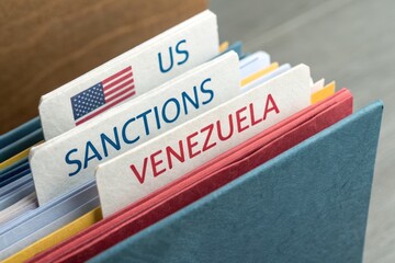 Venezuela crisis highlighted by US sanctions document folder, symbolizing economic pressure and international relations tension