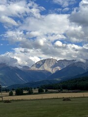 Serene rural scene featuring towering mountains and sky